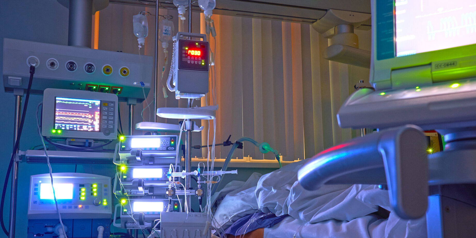 Glowing Monitors In Intensive Care Department. Nigth Shift At Icu, Patient In Critical State.